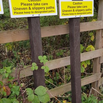 Caution sign mounted on plastic post